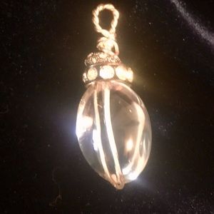 Clear crystal quartz pendant with rhinestones.